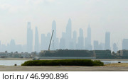 View from the river shore and embankment on skyscrapers in the morning haze. Стоковое фото, фотограф David Kashakhi / Фотобанк Лори