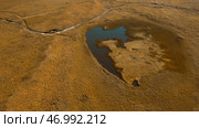 Idyllic countryside landscape with tiny lake in dried yellow field. Стоковое фото, фотограф David Kashakhi / Фотобанк Лори