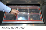 Close up of manager hands checking the quality of plastic small boxes, quality inspection.f plastic packing from environmentally friendly and safe for food storage materials. Стоковое фото, фотограф David Kashakhi / Фотобанк Лори