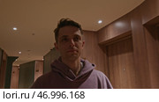 Young man walking in corridor of hotel building. Стоковое фото, фотограф David Kashakhi / Фотобанк Лори