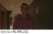 Young man in pink oversize hoodie at the hotel. Стоковое фото, фотограф David Kashakhi / Фотобанк Лори