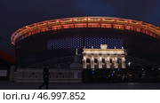 Illuminated night city with sports arena and street. Стоковое фото, фотограф David Kashakhi / Фотобанк Лори