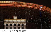 Illuminated night city with sports arena and street. Стоковое фото, фотограф David Kashakhi / Фотобанк Лори