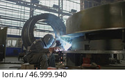 Industrial part with welder at machine-building plant. Стоковое фото, фотограф David Kashakhi / Фотобанк Лори