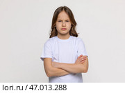 Negative human emotions, reactions and feelings. Isolated shot of moody displeased angry little girl crossing arms on her chest, pouting lips, having offended facial expression, being capricious. Стоковое фото, фотограф Ирина Михайличенко / Фотобанк Лори