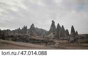 Natural rock formations, valley with cave houses in Cappadocia, Turkey. Стоковое фото, фотограф David Kashakhi / Фотобанк Лори