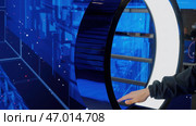 IT specialist standing In front of modern computer and activating data center with gestures. Стоковая иллюстрация, иллюстратор David Kashakhi / Фотобанк Лори