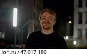 A night portrait with lanterns and a man with stubble who laughs and poses. Стоковое фото, фотограф David Kashakhi / Фотобанк Лори