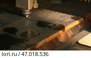 The process of cutting parts from a sheet of metal using a CNC machine. Стоковое фото, фотограф David Kashakhi / Фотобанк Лори