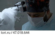 Concept of health care and medicine, doctor standing by microscope. Стоковое фото, фотограф David Kashakhi / Фотобанк Лори