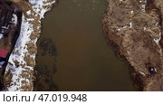 Aerial View of a Turbid River with Beautiful Snowy Banks Surrounded by Natures Landscape. Стоковое фото, фотограф David Kashakhi / Фотобанк Лори