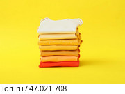 Стек детской одежды на цветном фоне. Стоковое фото, фотограф Pixel_shot / Фотобанк Лори