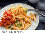 Вкусная паста пенне с соусом болоньез на тарелке, крупным планом. Стоковое фото, фотограф Pixel_shot / Фотобанк Лори