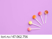 Композиция со сладкими леденцами на фиолетовом фоне. Стоковое фото, фотограф Pixel_shot / Фотобанк Лори