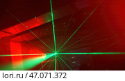 Lines of bright lasers shine in busy nightclub. Стоковая иллюстрация, иллюстратор David Kashakhi / Фотобанк Лори