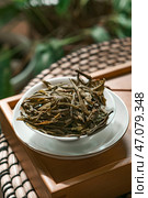 A Bowl Displaying Freshly Dried Green Tea Leaves, Perfectly Dried for Maximum Flavor and Aroma. Стоковое фото, фотограф David Kashakhi / Фотобанк Лори