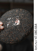 Traditional Compressed Puerh Tea Disc is an ancient Chinese beverage with rich complexity. Стоковое фото, фотограф David Kashakhi / Фотобанк Лори