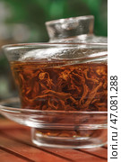 An Elegant Glass Teapot Perfect for Steeping Tea Leaves and Enhancing Your Tea Experience. Стоковое фото, фотограф David Kashakhi / Фотобанк Лори
