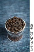 A CloseUp View of Dark Granular Spice Located in a Clear Container for Cooking Use. Стоковое фото, фотограф David Kashakhi / Фотобанк Лори