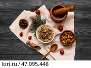 Миски с традиционной украинской кутьей, ветка ели и рождественские шары на черном деревянном фоне. Стоковое фото, фотограф Pixel_shot / Фотобанк Лори