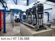 Industrial Water Pumping System Designed for Efficiency and Durability in an Indoor Facility. Стоковое фото, фотограф Aleksandr Golubev / Фотобанк Лори