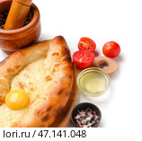 Вкусные хачапури по-аджарски со специями на белом фоне. Стоковое фото, фотограф Pixel_shot / Фотобанк Лори