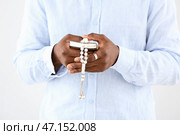 Афро-американский мусульманин с Кораном и бисером на светлом фоне, близком расстоянии. Стоковое фото, фотограф Pixel_shot / Фотобанк Лори