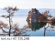 Beautiful calm landscape of Baikal Lake on May evening. View from coast of Olkhon Island to famous Shamanka Rock or Burkhan Cape - natural landmark of lake. Natural background. Spring travels. Стоковое фото, фотограф Виктория Катьянова / Фотобанк Лори