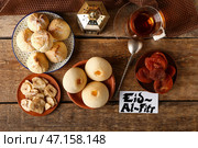 Вкусные восточные сладости с чаем и поздравительной открыткой на Ид аль-Фитр (Праздник разговения) на деревянном фоне. Стоковое фото, фотограф Pixel_shot / Фотобанк Лори