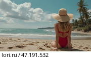 A woman on vacation, sitting in a swimsuit and a wide-brimmed straw hat on the beach on a sunny day and looking at the sea. Стоковое AI-изображение, AI-художник Photojuli / Фотобанк Лори