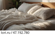 The interior of a modern house. A minimalistic cozy beige bedroom interior with a plaid, pillows, a headboard, linen linens and a bedside table. Стоковое AI-изображение, AI-художник Photojuli / Фотобанк Лори