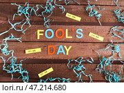 April Fools Day made of colored letters, funny notes and paper on wooden background. Стоковое фото, фотограф Елена Руй / Фотобанк Лори