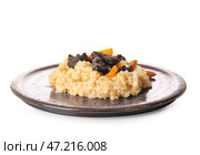 Тарелка с вкусной овсянкой, черносливом, курагой и миндальными орехами на белом фоне. Стоковое фото, фотограф Pixel_shot / Фотобанк Лори