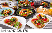 Set of many plates with tasty vegetarian food and glass of wine. Стоковое фото, фотограф Яков Филимонов / Фотобанк Лори