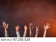 Руки протестующих на темном фоне. Стоковое фото, фотограф Pixel_shot / Фотобанк Лори