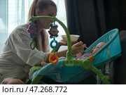Moments of Nurturing Joy During Mealtime for a Little One. Стоковое фото, фотограф Aleksandr Golubev / Фотобанк Лори