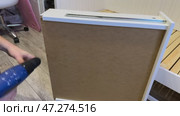 The man is assembling pull-out shelves for the sofa bed. He installs the bottom of the shelf and secures it with screws. Стоковое видео, видеограф Vadzim Yakubovich / Фотобанк Лори
