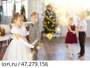 Children rehearsing ballroom dance for upcoming Christmas party at school. Стоковое фото, фотограф Яков Филимонов / Фотобанк Лори