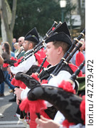St. Patrick's day celebration parade - musicians in Irish kilts with bagpipes marching in the street (2024 год). Редакционное фото, фотограф Дмитрий Рухленко / Фотобанк Лори