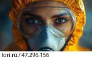 A person in a protective suit, close-up of the face. He or she is wearing a yellow chemical suit, protective goggles, and a respirator that covers the lower part of the face. The eyes look intense and focused, as if the person is in a biological or chemical hazard zone.The goggles show traces of condensation or dirt, which emphasizes the extreme working conditions. The background is blurred and darkened, creating a tense atmosphere, possibly related to scientific research, an epidemic, a disaster, or working in a contaminated area.The composition of the shot emphasizes the eyes and details of the protective gear, which conveys a sense of anxiety, readiness, and determination. Стоковое AI-изображение, AI-художник Анна Кривицкая / Фотобанк Лори