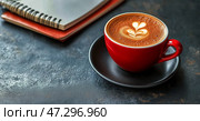Warm Cup of Coffee With Latte Art on a Textured Surface Beside Notebooks and a Sketchpad. Стоковое AI-изображение, AI-художник Юлия Гапеенко / Фотобанк Лори