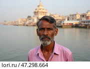 In Varanasi, a man stands near the banks of the Ganges, lost in thought as the tranquil waters reflect the ancient city's essence at dawn Generative AI. Стоковое AI-изображение, AI-художник Юлия Петровская / Фотобанк Лори