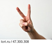 A Hand Making the Peace Sign Against a Plain White Background During a Calm and Peaceful Moment Conveying Positivity and Goodwill. Стоковое AI-изображение, AI-художник Sergey Grishin / Фотобанк Лори