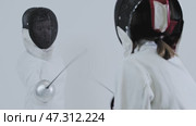 Fencing - two young women fencers in white suits training the fight. Стоковое видео, видеограф Константин Шишкин / Фотобанк Лори