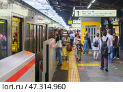 Osaka, Japan - Sep 22 2024, Panoramic view of the platform of the railway station with an electric train from which people enter and exit, JR Osaka Station, at daytime, Osaka, Japan. Редакционное фото, фотограф Сергей Богомяко / Фотобанк Лори