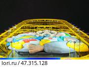 Osaka, Japan - Sep 22 2024, panoramic view from below of Don Quijote Dotonbori shopping and entertainment complex and Ferris wheel, in Dotonbori district, on canal corniche, at nighttime, Osaka, Japan. Редакционное фото, фотограф Сергей Богомяко / Фотобанк Лори