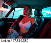 A woman with short hair sits confidently in the backseat of a car, illuminated by colorful neon lights, showcasing a chic outfit and a striking expression. Стоковое AI-изображение, AI-художник Sergey Grishin / Фотобанк Лори