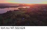 A serene sunset over a lake in a Village Surrounded by Beautiful nature. Стоковое видео, видеограф Михаил Матвеев / Фотобанк Лори
