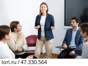 Competent female tutor teaching students in college classroom. Стоковое фото, фотограф Яков Филимонов / Фотобанк Лори