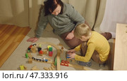 Grandmother playing toys with young grandson indoor. Old woman granny studying with her grandchild at weekend. Senior female having fun with kid. Happy multigeneration family video. Elderly Grandma. Стоковое видео, видеограф Марина Демидюк / Фотобанк Лори